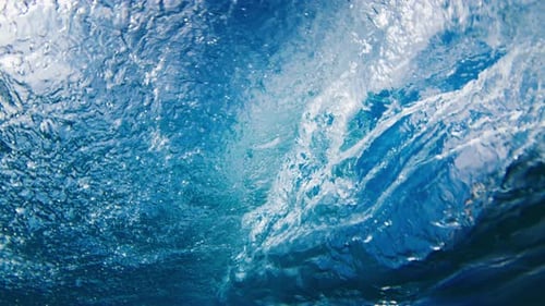 Crystal Clear Ocean Wave Breaks on the Shore in the Maldives