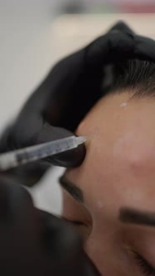 Injection in Forehead Performed by Medical Professional