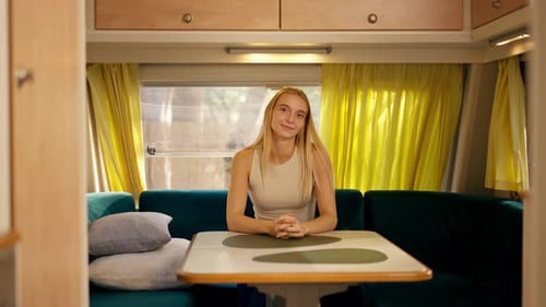 Blonde Woman Smiling in Bright Camper Interior