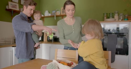 Family Unpacking Groceries in Kitchen Together