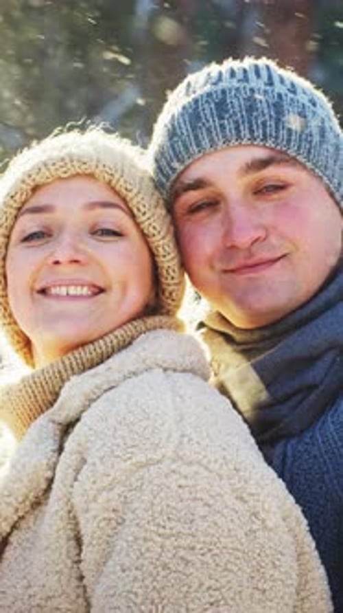 Couple Enjoys Winter Day Outdoors in Warm Clothing and Smiles