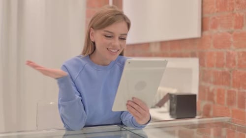 Smiling Woman Video Calling on Tablet at Home