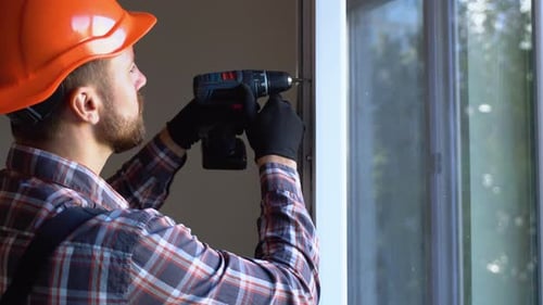 Handyman Adjusting White Pvc Plastic Window Indoors