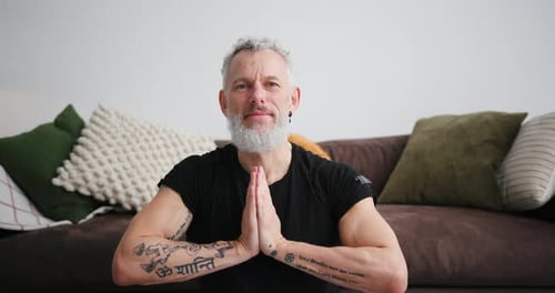 Mature Man Meditating Indoors