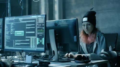 Hackers Working on Computers in Dark Room