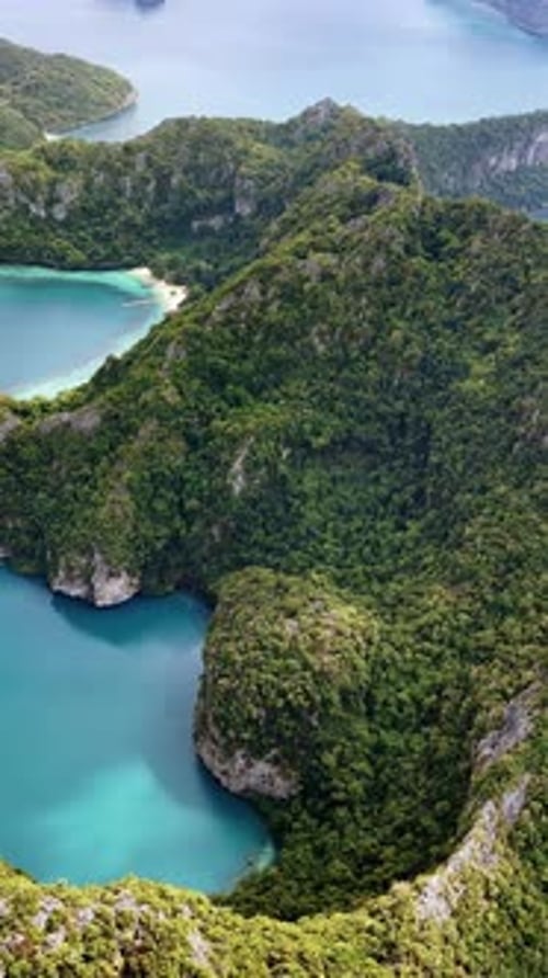 Aerial drone view of a tropical island with white sand beaches and turquoise water bays in southern