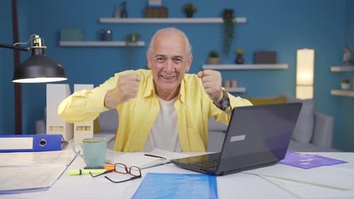 Home office worker old man experiencing joy looking at camera.
