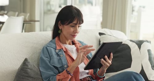 Woman Relaxing at Home Using a Tablet