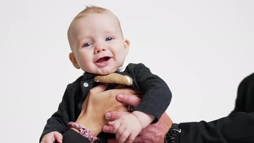 Smiling Infant in Parents' Arms