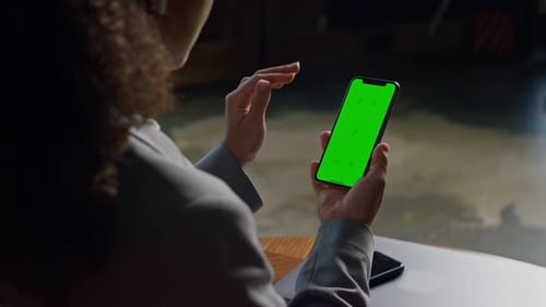 Woman Scrolling on Smartphone with Green Screen