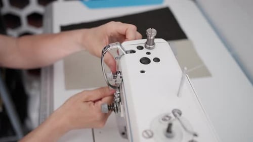 Woman Adjusting Thread on Industrial Sewing Machine Close-Up