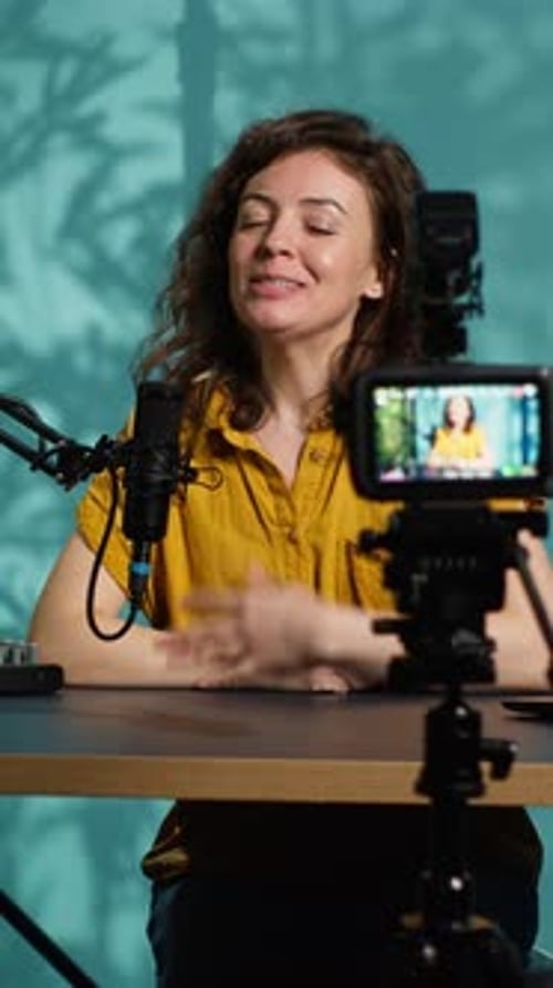 Woman Recording Video with Microphone in Studio