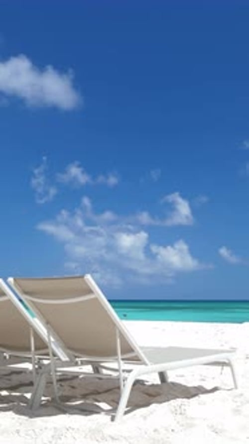Beach Scene with Sunbeds Close to Caribbean Sea Tropical Island with Sunbeds on Sandy Shore Vertical