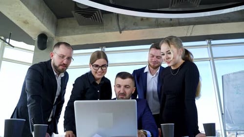 Team Leader Explaining Ideas To Collegues. Group of employees talking in modern office