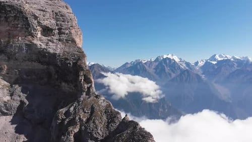 Snowy Mountains and Cliffs Under a Bright Sky