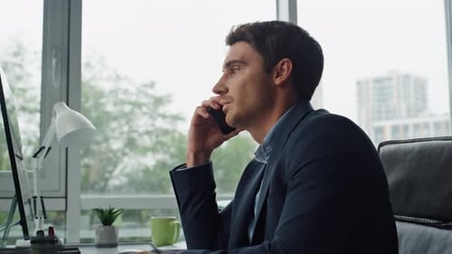 Man talking on smartphone in modern office