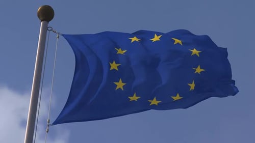 European Union Flag Waving in Wind with Blue Sky Background