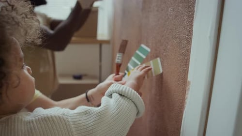 Woman and Child Selecting Paint Colors Together