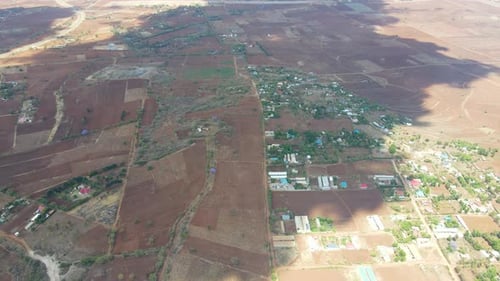 High jib down of a beautiful landscape in Kenya with green farms