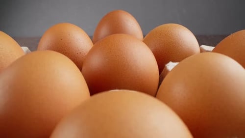 Perfectly Laid Eggs Highlighting Their Rustic Charm Against Dark Backdrop