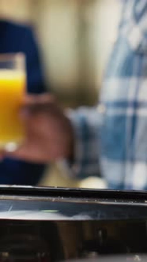 Vertical Video Jolly Boyfriend and Girlfriend Taking Bread Out of Toaster for Breakfast Meal