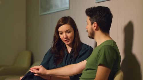 Woman and Man Sitting Together Talking Indoors