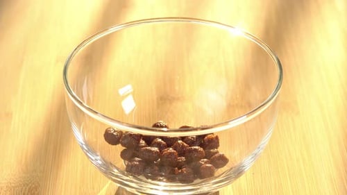 Pouring Chocolate Cereal Balls into a Bowl