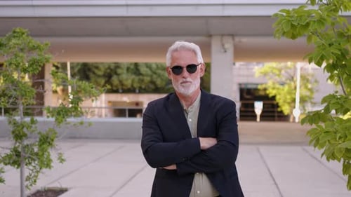Senior Man Takes off Sunglasses and Smiles