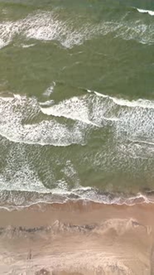 Waves Crashing Along Lakolk Beach in Jutland Denmark on a Sunny Day with Scenic Views