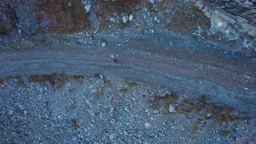 The Guy is Walking in the Mountains Along Gorge
