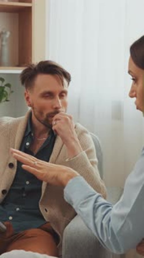 Man in Therapy Discussing Problems With Therapist Indoors