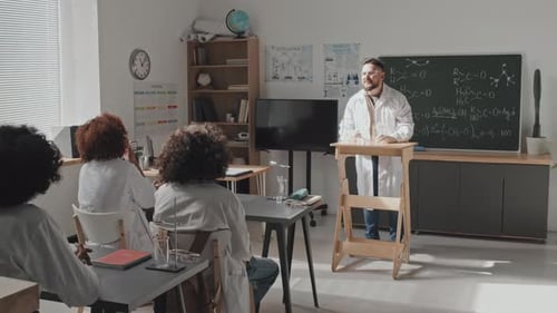 Teacher Giving Science Lecture in Classroom