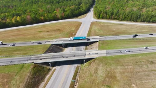 Aerial View of Freeway Overpass Junction with Fast Moving Traffic Cars and Trucks in American Rural