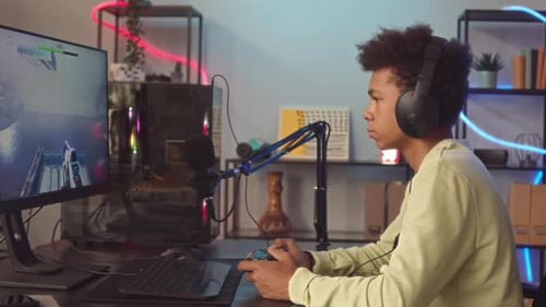 Gamer Boy Playing FPS PC Game at Home