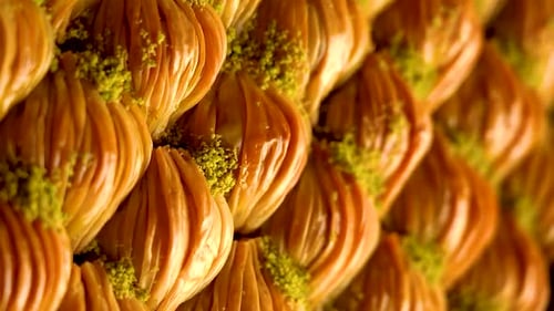 Ein Tablett mit türkischen Baklava-Bonbons mit Pistazien, Zeitlupenvideo, vertikales Video