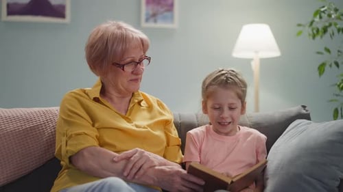 Grandmother and Granddaughter Reading a Book Together