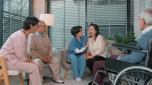 Healthcare Worker Comforts Crying Mature Woman in Living Room