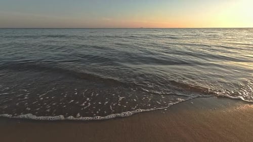 Calm water - sea waves at the beach at the morning sunrise around 6a - close up. Baltic sea.