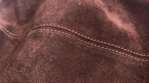 Macro Shot of Textured Brown Suede Fabric with Stitching