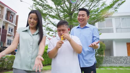 Asiatische attraktive Familie, Eltern spielen mit kleinem Sohn im Garten.