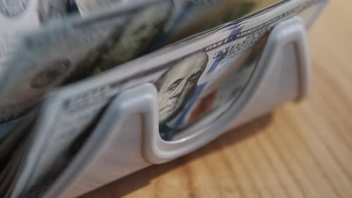 Money Counter Counts Stack of US Hundred Dollar Bills