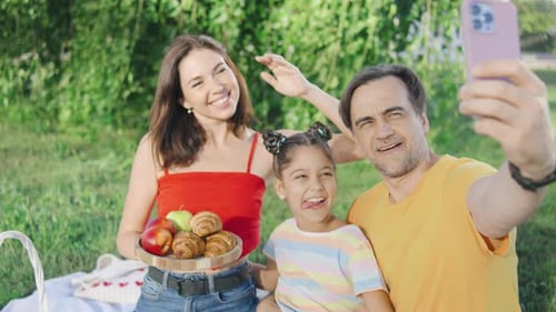Happy Family Picnic in the Park Taking Photo
