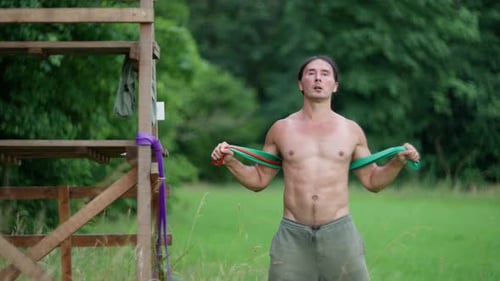 Fit Man Exercising with Resistance Bands Outdoors