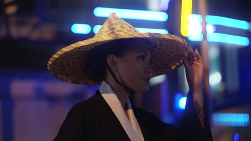 Woman in Traditional Hat Posing at Night