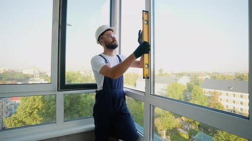 Worker Using Level to Ensure Precise Window Installation