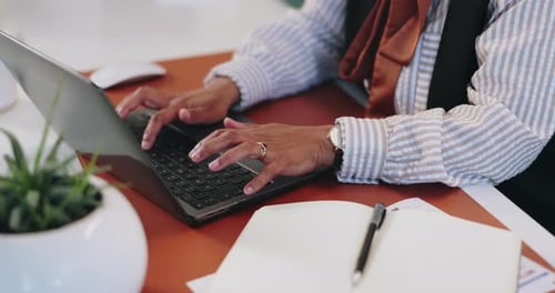 Woman Typing on Laptop at Desk
