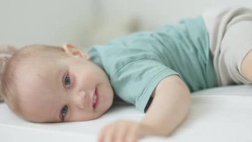 Adorable Infant Lies on Side