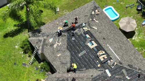 Roofers Working on House Roof Aerial View