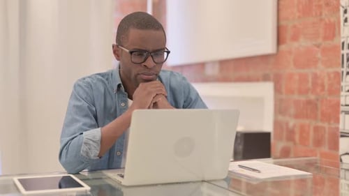 Man Thinking in Front of Computer at Desk