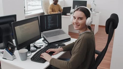 Woman Works at Computer in Bright Office